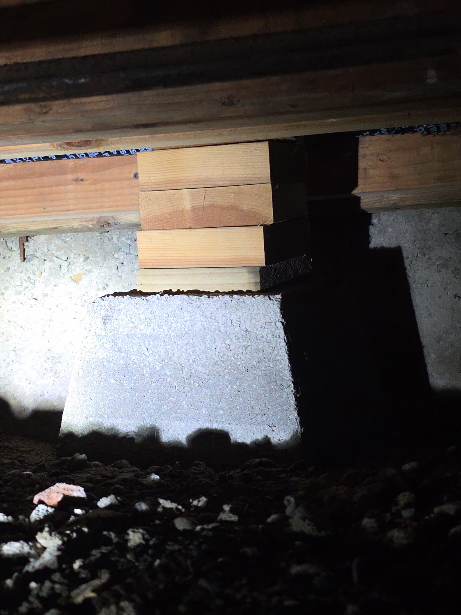 Close-up of wood blocks unsafe foundation repair with stacked wood blocks